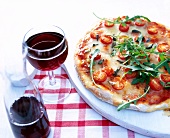 Caprese pizza garnished with arugula on board