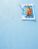 Piece of Asian pizza on blue plate