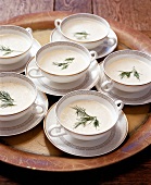 Trout soup garnished with herbs in cups