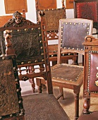 Different types of old wooden chair restored with leather craft