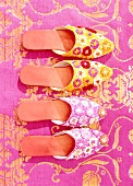 Two pairs of oriental slippers decorated with fabric, overhead view