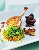 Guinea fowl breast with mangetout and blinis on white background