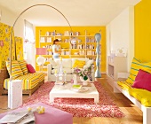 Woman standing behind sofa in yellow and white living room with several accessories