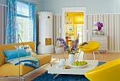 View of living room with yellow furnitures and striped wallpaper