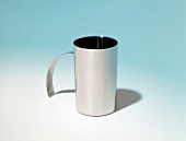 Milk jug for whisk on blue white background