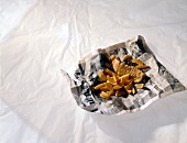 Fish and chips in newspaper on white background