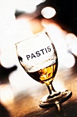 Glass of pastis on wooden table