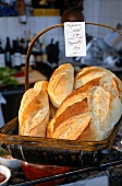 Various baguette bread in basket with price tag