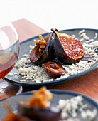 Figs with shredded Roquefort cheese flakes and dates on plate