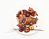Goose breast with coriander and apples on plate