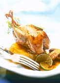 Close-up of partridge with quince and lime sauce on plate