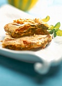 Close-up of chicken bastilla with baked pumpkin on plate