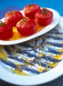 Sardines in lemon marinade and tomato jelly on plates