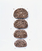 Various slices of rye bread with sourdough on white background