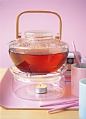 Close-up of teapot with tea on hot plate