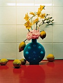 Lemons, orchid and Japanese Peony flower in vase