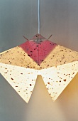 Colourful paper lamp hanging on white background