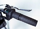 Close-up of black handlebar with twist-grip circuit on touring bike
