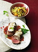 Close-up of lamb fillet with goat cheese on plate