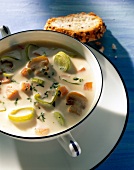 Cheese soup with leeks and mushrooms in soup bowl