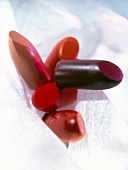 Close-up of various shades of red lipstick on white background