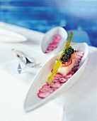 Confit of sea bass with oxtail with osetra caviar on radish in serving dish
