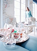 Bomboniere sweets in glass stand with aperitifs and carafes on tray