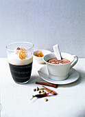 Spice coffee in glass and hot chocolate with chilli on table