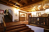 Interior of hotel with wooden staircase and ceiling, Germany