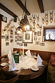 Laid table with photo frames on wall in restaurant, Germany