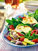 Mixed vegetable salad with goat cheese on plate