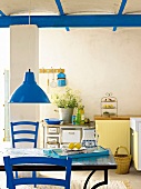 Kitchen with blue furniture and beam