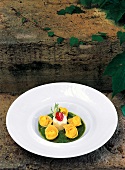 Ricotta tortelli with tarragon pesto and pecorino on plate