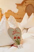 Close-up of heart shaped card on pillow, Ebner's Waldhof, Germany
