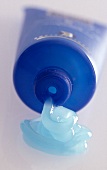 Close-up of light blue skin cream squeezed out of tube
