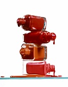 Close-up of open nail polish bottles against white background