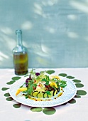 Raw sea bream with courgette flowers on plate