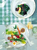 Blanched leafy vegetables, anchovy paste and fresh raw vegetables on plate