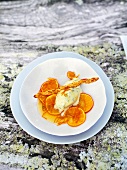 Olive ice cream with clementine compote served on plate