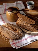 Spelled flaxseed bread on plate with kefir filled cup