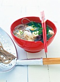 Japanese miso soup with soba noodles and chopstick on it