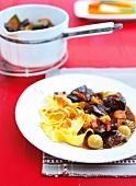 Pasta with meat and burgundy wine served on plate