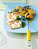 Roasted potatoes with feta on frying spatula