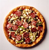 Pizza topped with sausages on white background