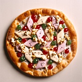 Pizza topped with marshmallows, green cherries, red cherries and popcorn