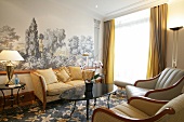 Sofa, table and chairs with wall painting in hotel room, Switzerland