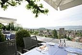 Table laid on terrace of restaurant, Switzerland