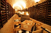 Wine bottles in wooden crates at wine cellar of restaurant, Czech Republic