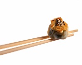 Chopsticks with dim sum made of lamb and cabbage