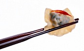 Close-up of chopsticks with dried shrimp dim sum
